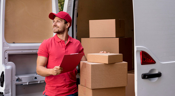 Man holding boxes from a truck